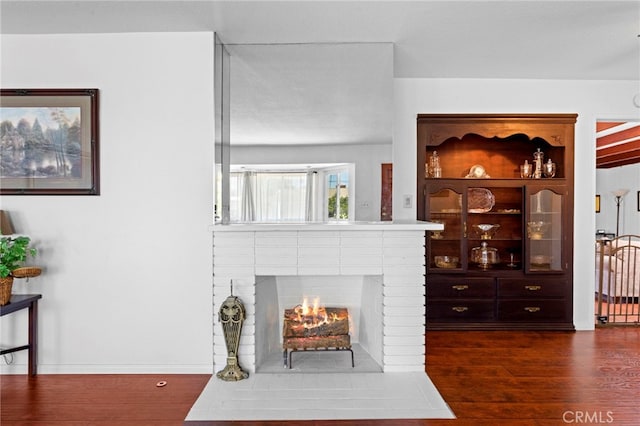 9802 Swallow Ln, Garden Grove, CA 92841 - living area featuring dark wood-style floors and a fireplace