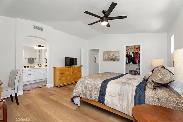 35 Colony Way, Aliso Viejo, CA 92656 - bedroom featuring light wood-style flooring, vaulted ceiling, connected bathroom, ceiling fan, and a walk in closet
