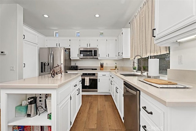 35 Colony Way, Aliso Viejo, CA 92656 - kitchen featuring appliances with stainless steel finishes, wood finished floors, open shelves, white cabinetry, and recessed lighting