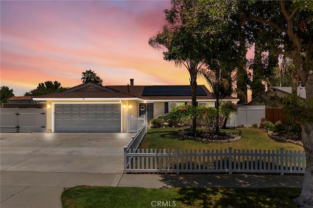 1935 Adobe Ave, Corona, CA 92882 - ranch-style house featuring a fenced front yard, driveway, a garage, roof mounted solar panels, and a gate