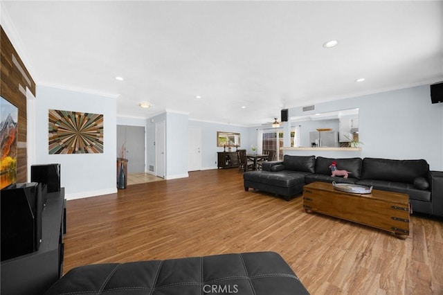 1935 Adobe Ave, Corona, CA 92882 - living area featuring wood finished floors, ornamental molding, ceiling fan, and recessed lighting