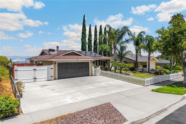 1935 Adobe Ave, Corona, CA 92882 - ranch-style house featuring a gate, a fenced front yard, solar panels, and concrete driveway