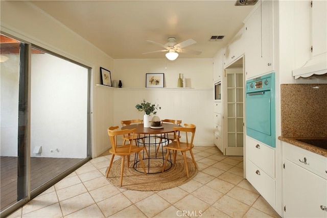 1852 Alpha Rd, Glendale, CA 91208 - dining area with a ceiling fan, wainscoting, and light tile patterned floors