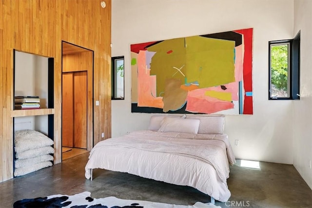 4190 Shadow Canyon Rd, Templeton, CA 93465 - bedroom with concrete flooring, a high ceiling, and wooden walls