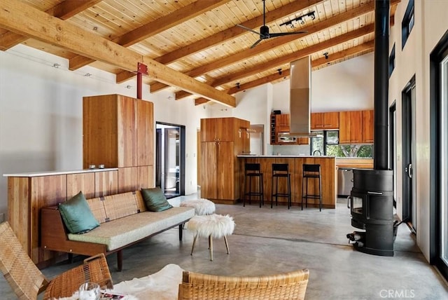 4190 Shadow Canyon Rd, Templeton, CA 93465 - living area featuring a wood ceiling with exposed beams, concrete floors, high vaulted ceiling, a wood stove, and a ceiling fan