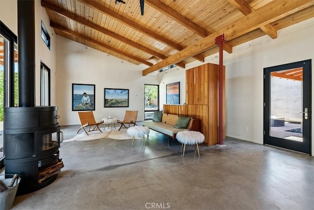 4190 Shadow Canyon Rd, Templeton, CA 93465 - living room featuring a wooden ceiling with exposed beams, a wood stove, concrete flooring, and high vaulted ceiling