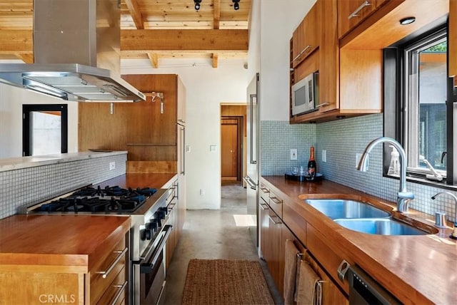 4190 Shadow Canyon Rd, Templeton, CA 93465 - kitchen with island exhaust hood, stainless steel appliances, brown cabinets, finished concrete floors, and decorative backsplash