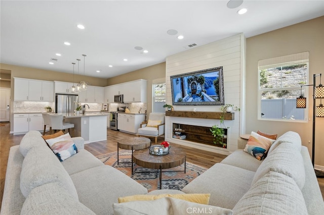 28816 Sedge Ln, Saugus, CA 91350 - living room featuring healthy amount of natural light, recessed lighting, light wood-style flooring, and a chandelier