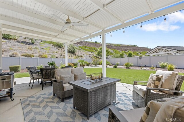 28816 Sedge Ln, Saugus, CA 91350 - fenced backyard with an outdoor hangout area, ceiling fan, outdoor dining area, and a patio