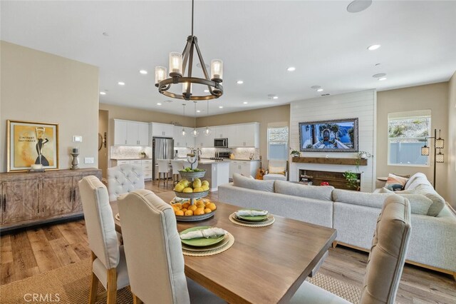 28816 Sedge Ln, Saugus, CA 91350 - dining area featuring a chandelier, light wood-type flooring, plenty of natural light, and recessed lighting
