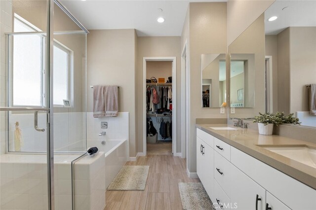 28816 Sedge Ln, Saugus, CA 91350 - bathroom with a bath, double vanity, a shower stall, and a spacious closet