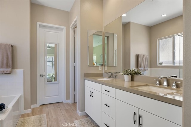 28816 Sedge Ln, Saugus, CA 91350 - bathroom featuring double vanity, a garden tub, and recessed lighting