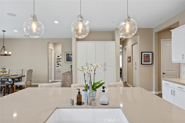 28816 Sedge Ln, Saugus, CA 91350 - kitchen with light countertops, decorative light fixtures, white cabinets, a chandelier, and recessed lighting