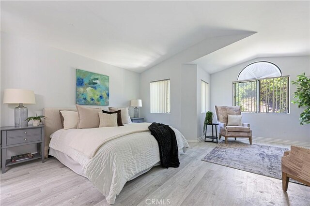 15775 Caminito Atico, San Diego, CA 92128 - bedroom featuring multiple windows, lofted ceiling, and light wood-style flooring