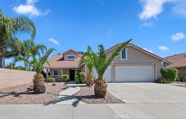 27242 Cabrillo Dr, Menifee, CA 92586 - mediterranean / spanish-style house featuring concrete driveway, stucco siding, a tile roof, a garage, and covered porch