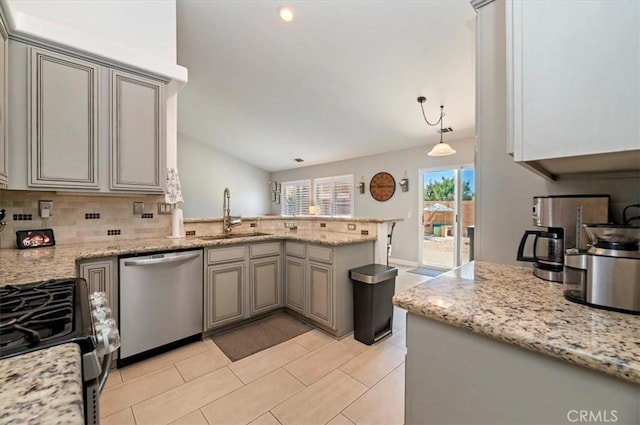 27242 Cabrillo Dr, Menifee, CA 92586 - kitchen with stainless steel dishwasher, a peninsula, tasteful backsplash, lofted ceiling, and light tile patterned flooring