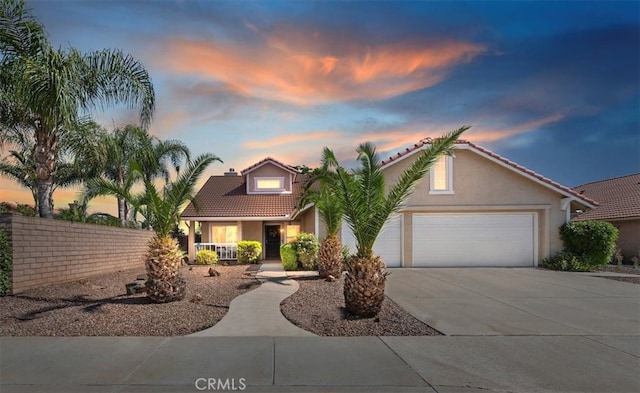 27242 Cabrillo Dr, Menifee, CA 92586 - mediterranean / spanish home featuring driveway, a tile roof, an attached garage, stucco siding, and a porch