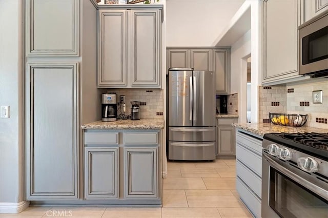 27242 Cabrillo Dr, Menifee, CA 92586 - kitchen with stainless steel appliances, gray cabinetry, tasteful backsplash, and light tile patterned flooring