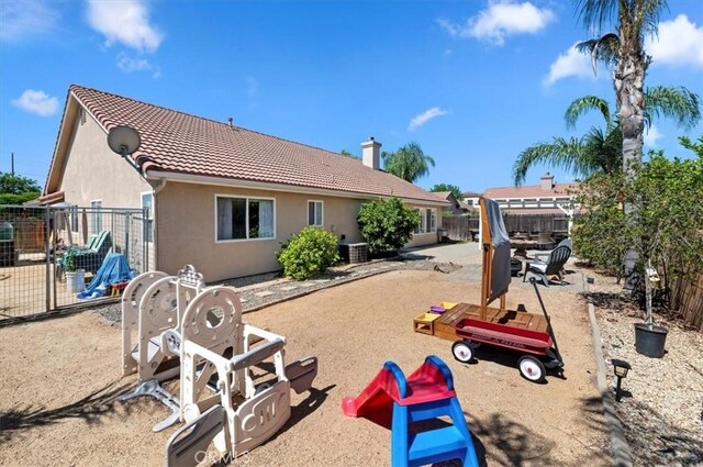 27242 Cabrillo Dr, Menifee, CA 92586 - rear view of house featuring a tiled roof, a fenced backyard, and stucco siding