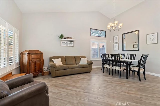 27242 Cabrillo Dr, Menifee, CA 92586 - living room with a chandelier, light wood-style flooring, and high vaulted ceiling