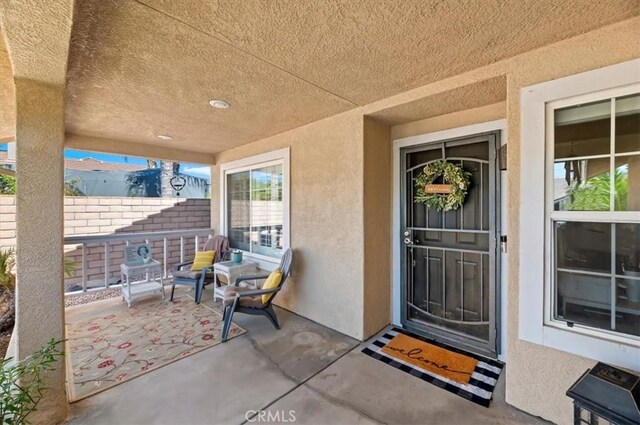 27242 Cabrillo Dr, Menifee, CA 92586 - view of exterior entry with stucco siding and a patio area