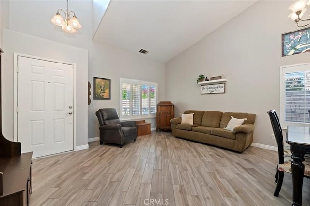 27242 Cabrillo Dr, Menifee, CA 92586 - living room featuring a chandelier, high vaulted ceiling, healthy amount of natural light, and light wood finished floors