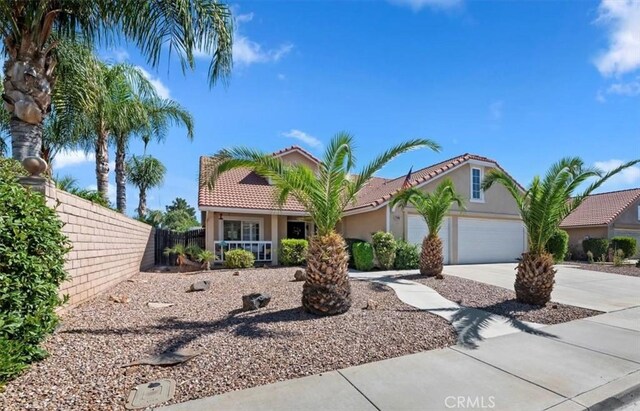 27242 Cabrillo Dr, Menifee, CA 92586 - mediterranean / spanish home featuring driveway, stucco siding, an attached garage, and a tiled roof