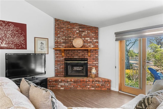 181 Eucalyptus Rd, Nipomo, CA 93444 - living area with vaulted ceiling, wood finished floors, and a brick fireplace