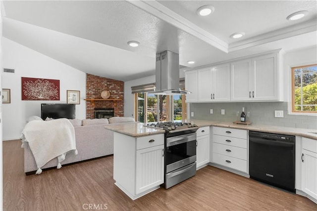 181 Eucalyptus Rd, Nipomo, CA 93444 - kitchen featuring black dishwasher, stainless steel gas range oven, a peninsula, wood finished floors, and vaulted ceiling