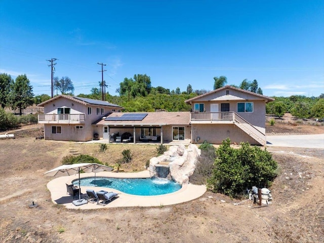 28880 Mac Tan Rd, Valley Center, CA 92082 - rear view of property with roof mounted solar panels, a patio, an outdoor pool, stairway, and stucco siding