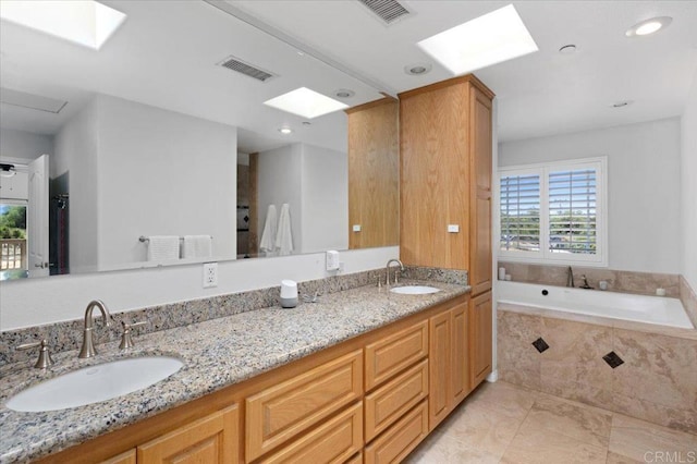 28880 Mac Tan Rd, Valley Center, CA 92082 - full bathroom with a skylight, double vanity, a garden tub, recessed lighting, and tile patterned flooring