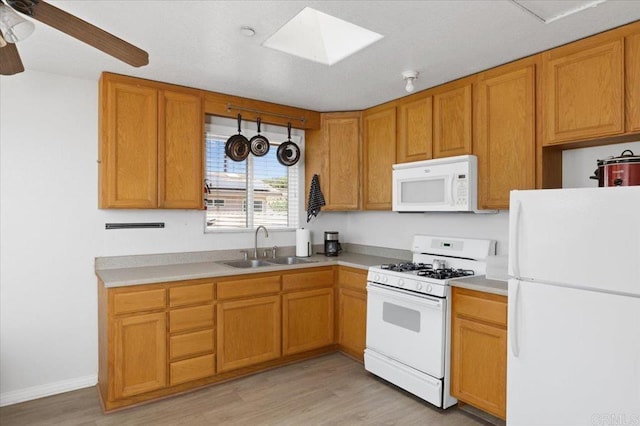 28880 Mac Tan Rd, Valley Center, CA 92082 - kitchen with white appliances, light wood-type flooring, a skylight, and light countertops