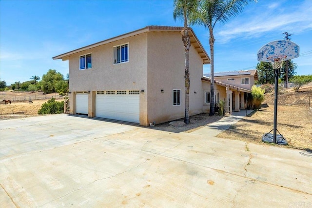 28880 Mac Tan Rd, Valley Center, CA 92082 - view of property exterior featuring driveway, stucco siding, and an attached garage