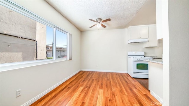 6045 Hazelhurst Pl, North Hollywood, CA 91606 - kitchen featuring white range with gas cooktop, under cabinet range hood, a ceiling fan, light wood-type flooring, and a textured ceiling