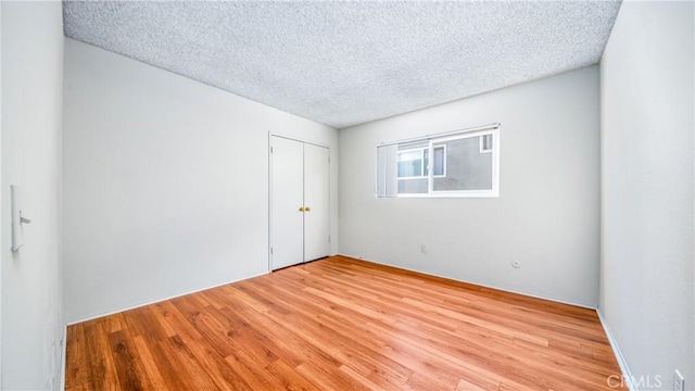 6045 Hazelhurst Pl, North Hollywood, CA 91606 - spare room with a textured ceiling and light wood-type flooring