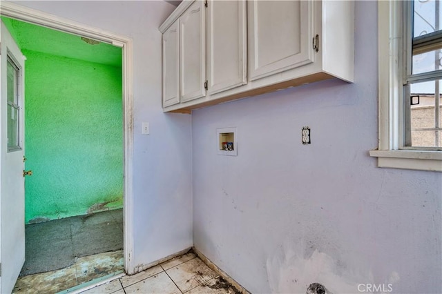 11860 Athens Way, Los Angeles, CA 90061 - washroom featuring hookup for a washing machine, cabinet space, and light tile patterned floors
