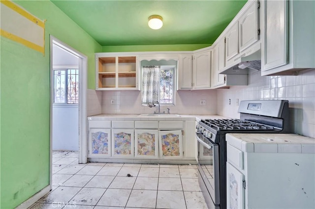 11860 Athens Way, Los Angeles, CA 90061 - kitchen featuring gas range, under cabinet range hood, tasteful backsplash, tile counters, and white cabinetry