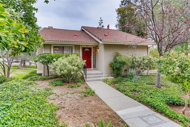 529 El Azul Cir, Oak Park, CA 91377 - view of front facade with stucco siding, a tiled roof, and a chimney