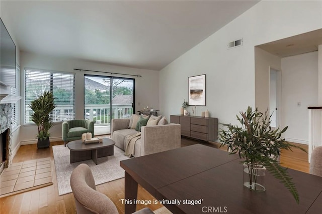 529 El Azul Cir, Oak Park, CA 91377 - living room with vaulted ceiling, wood finished floors, and a fireplace