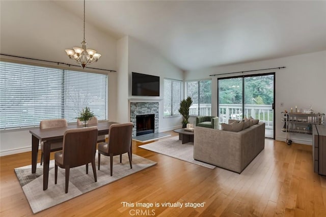 529 El Azul Cir, Oak Park, CA 91377 - dining space with light wood finished floors, a chandelier, a fireplace, and high vaulted ceiling