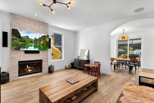 176 Saddlebow Rd, Bell Canyon, CA 91307 - living area with a chandelier, arched walkways, a fireplace, hardwood / wood-style floors, and ornamental molding