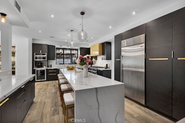 176 Saddlebow Rd, Bell Canyon, CA 91307 - kitchen featuring premium appliances, modern cabinets, beverage cooler, dark cabinets, and recessed lighting