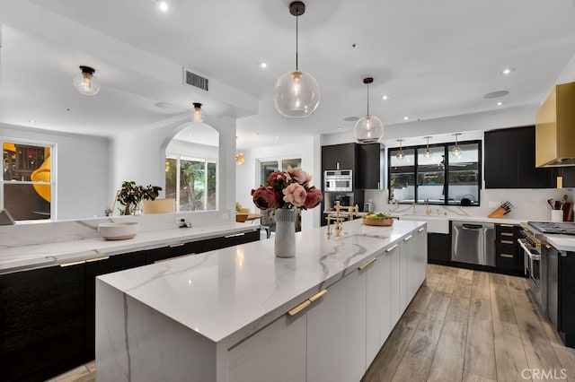 176 Saddlebow Rd, Bell Canyon, CA 91307 - kitchen with stainless steel appliances, dark cabinetry, modern cabinets, a large island, and recessed lighting