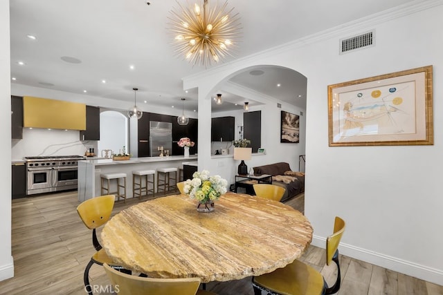 176 Saddlebow Rd, Bell Canyon, CA 91307 - dining room featuring arched walkways, light wood finished floors, a chandelier, recessed lighting, and crown molding