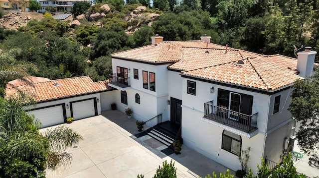 176 Saddlebow Rd, Bell Canyon, CA 91307 - view of front facade featuring a balcony, stucco siding, a tiled roof, a garage, and driveway