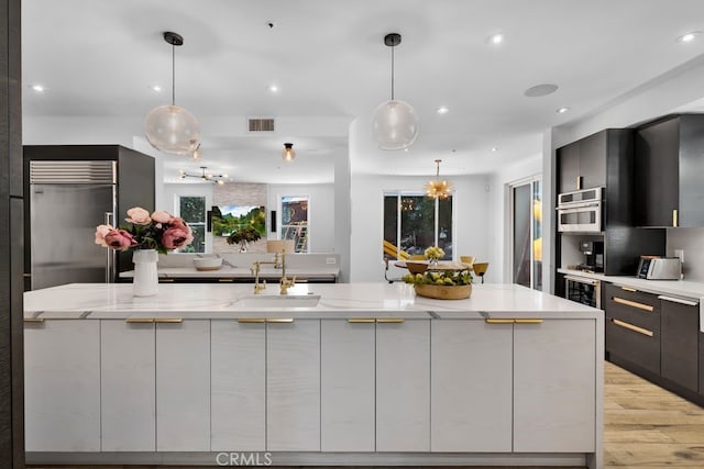 176 Saddlebow Rd, Bell Canyon, CA 91307 - kitchen with stainless steel built in fridge, modern cabinets, wine cooler, light wood-style floors, and recessed lighting