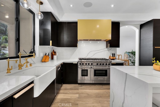 176 Saddlebow Rd, Bell Canyon, CA 91307 - kitchen featuring stainless steel appliances, dark cabinetry, light wood finished floors, recessed lighting, and light stone countertops