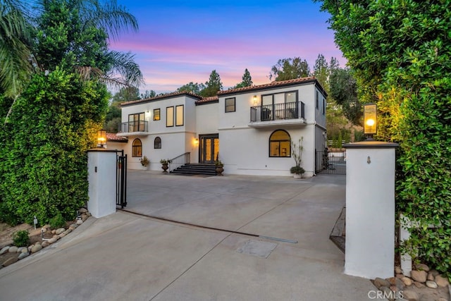 176 Saddlebow Rd, Bell Canyon, CA 91307 - mediterranean / spanish house featuring a balcony, a gate, stucco siding, and a tile roof