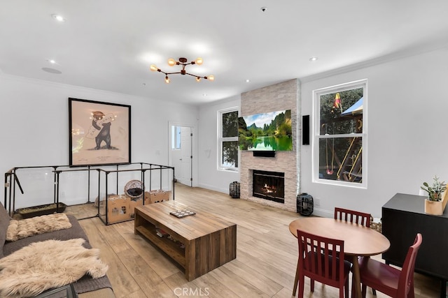 176 Saddlebow Rd, Bell Canyon, CA 91307 - living area featuring light wood-style floors, plenty of natural light, a chandelier, a fireplace, and crown molding