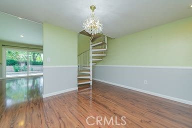 14 Featherwood, Irvine, CA 92612 - spare room featuring stairs, a chandelier, and wood finished floors